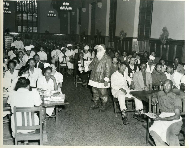 Holiday party for Duke dining staff in the 1950s. The room was segregated down the middle by race. Courtesy Theodore W. “Ted” Minah Records and Papers, Duke University Archives, David M. Rubenstein Rare Book & Manuscript Library, Duke University