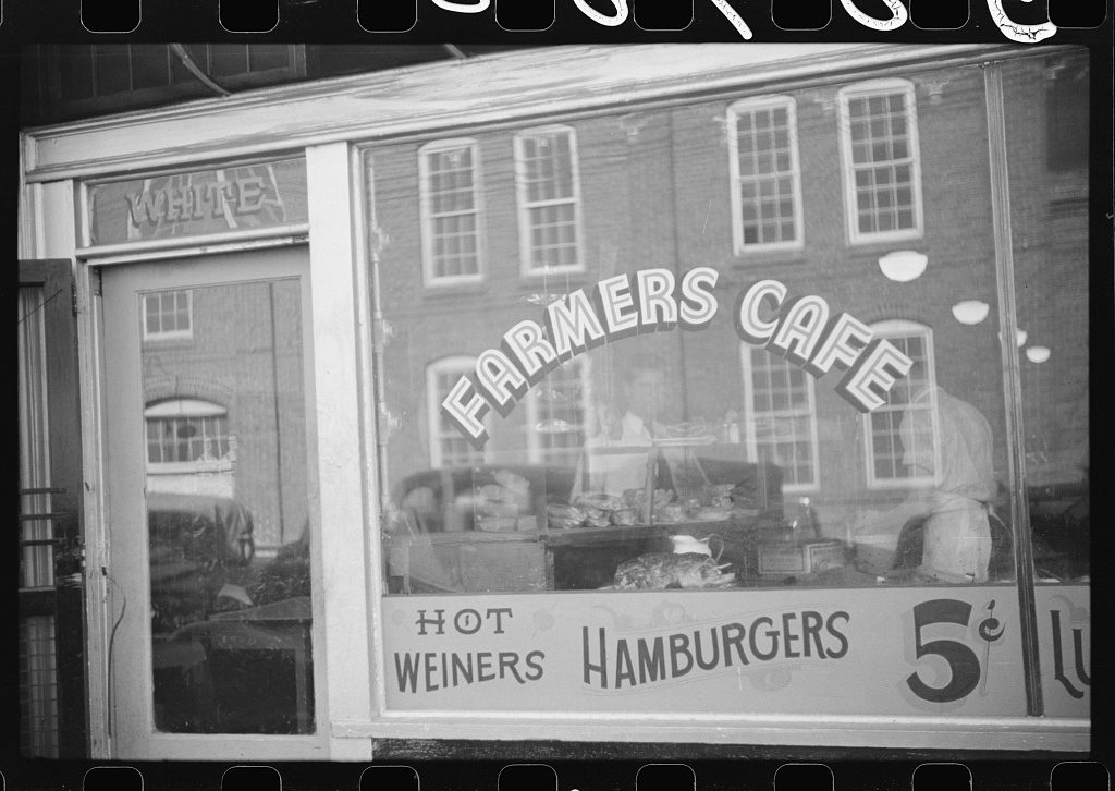 Farmers Cafe in downtown Durham, 1939, with Jim Crow signage in the top left corner indicating the white entrance. Courtesy Library of Congress, Prints & Photographs Division, FSA/OWI Collection,LC-USF33-030700
