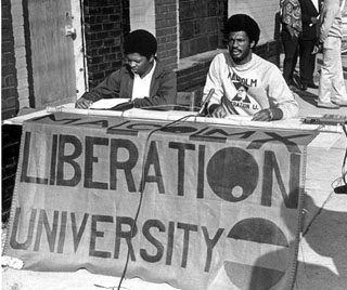 Howard Fuller and an unidentified person at the opening celebration of Malcolm X Liberation. Courtesy Durham Herald Co. Newspaper, North Carolina Collection, Louis Round Wilson Special Collections Library, University of North Carolina at Chapel Hill